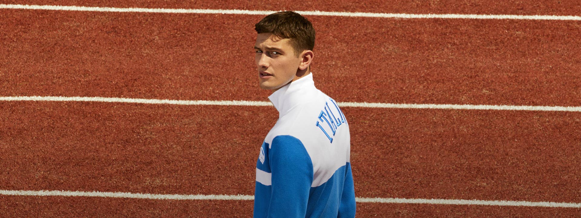 A male model is wearing a white and blue tracksuit from the Spring Summer 2023 Sport collection