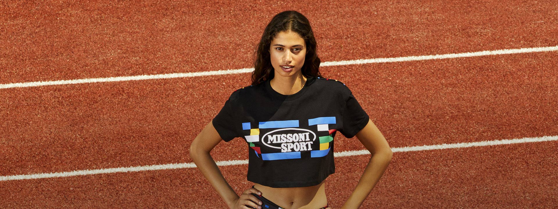 A model is wearing a black logo tank top from the Spring Summer 2023 Sport collection